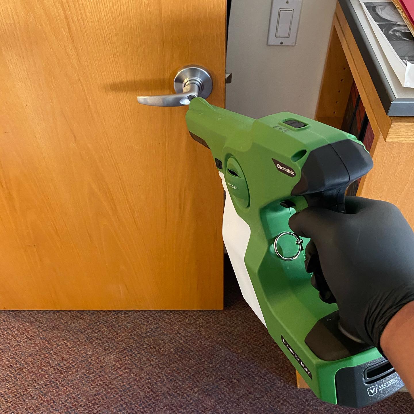 Disinfecting service with electrostatic sprayer Disinfecting doors NYC office with electrostatic sprayer.
