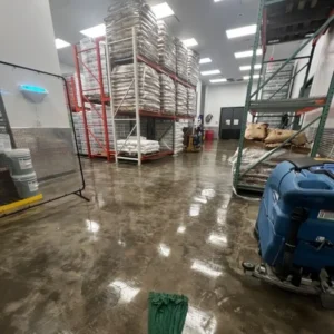 Cleaning and resurfacing concrete floor in warehouse