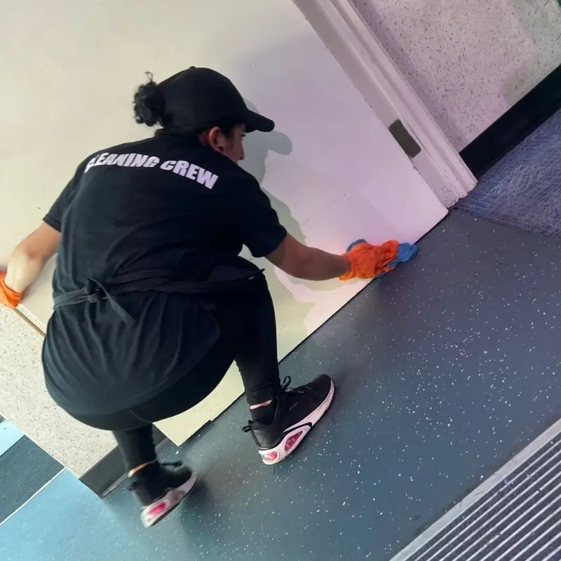 Cleaning door panels and floor boards in NYC office building