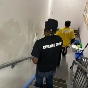 Facility maintenance repainting walls in office building