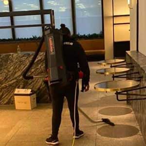 A professional commercial backpack vacuum cleaner used for heavy-duty cleaning tasks.