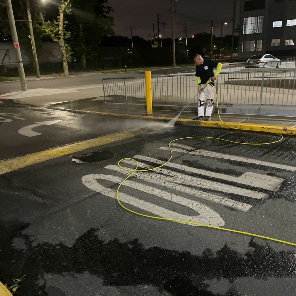 Power washing parking area at industrial facilities