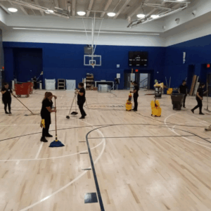 Cleaning hardwood maple sports floor at charter school in NYC