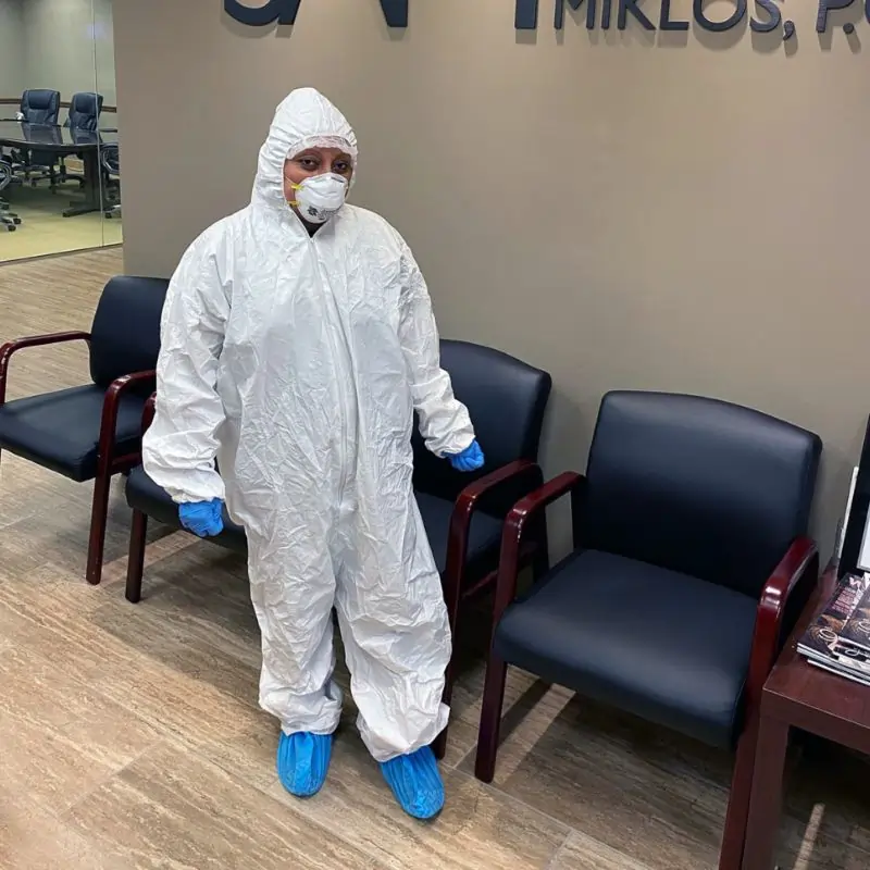 Cleaner wearing Personal Protective Equipment