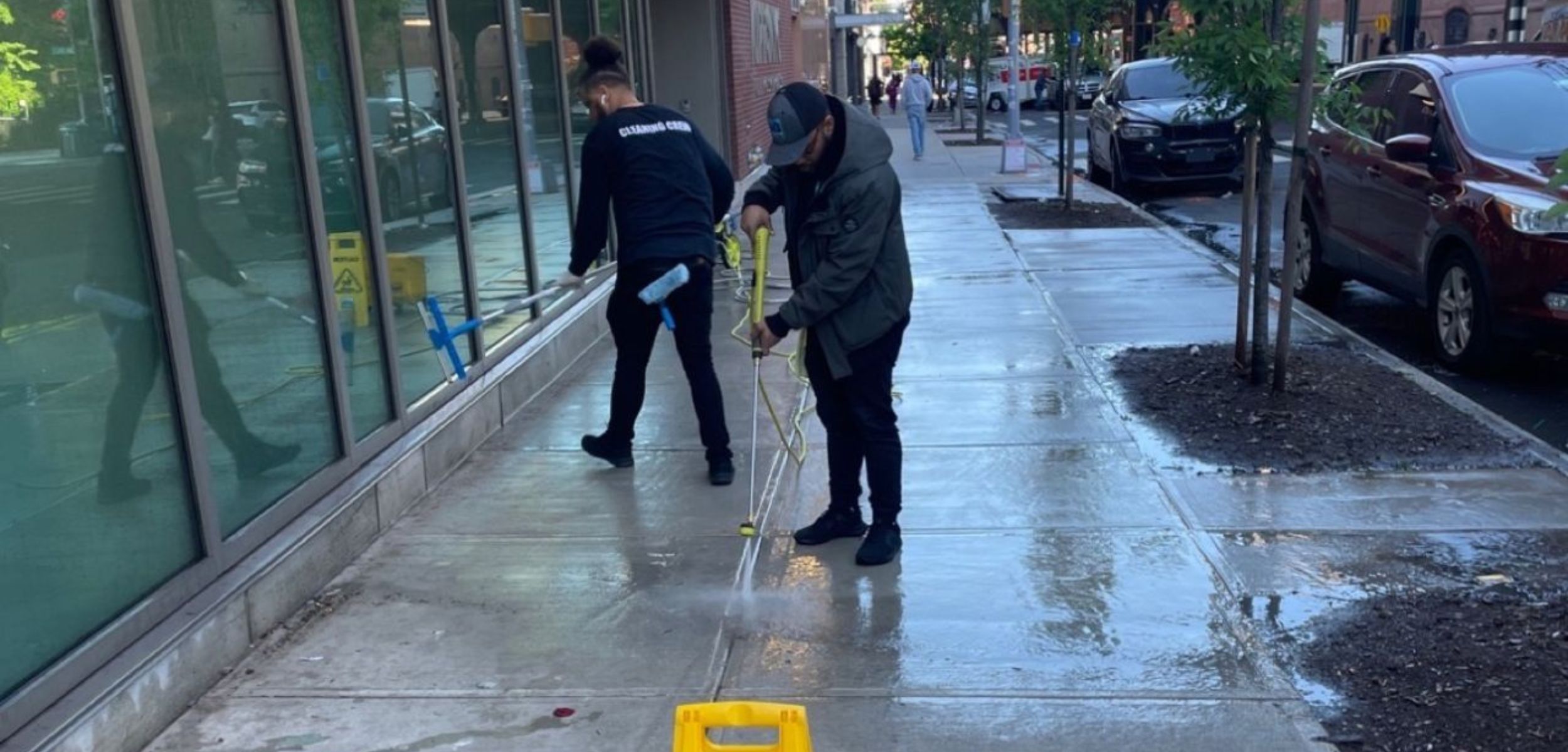 Pressure washing side walk in front of office building on Manhattan NYC