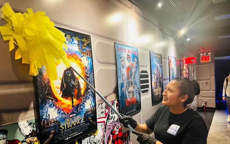 Dusting wall and picture frames in museum in NYC