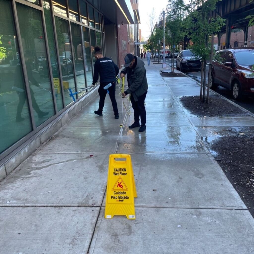 Spring cleaning - pressure washing sidewalk of office building