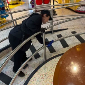 Cleaning metal handrails in Manhattan tourist attraction