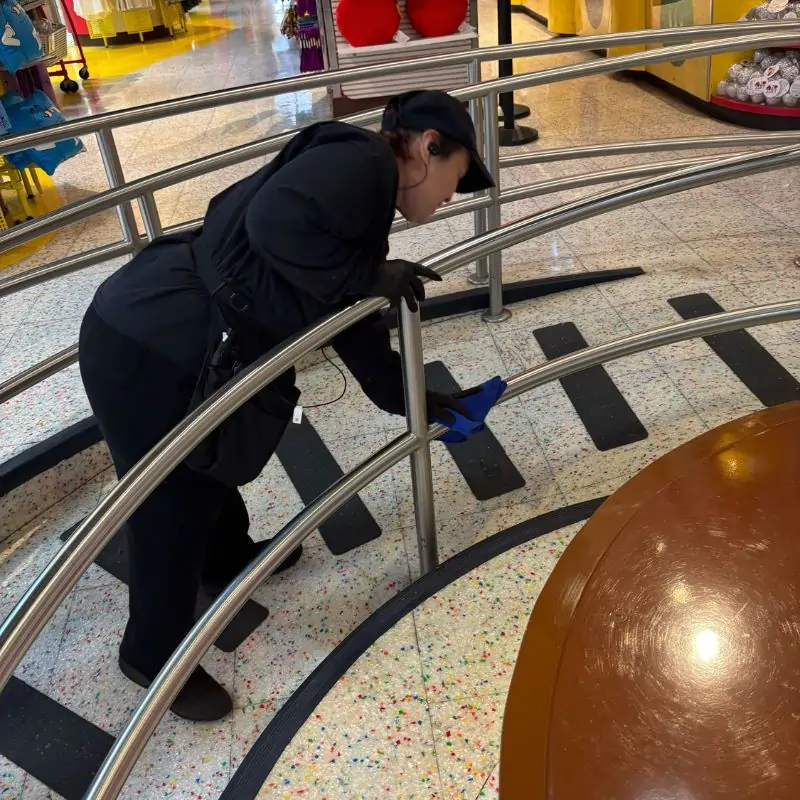 Cleaning metal handrails in Manhattan tourist attraction