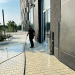 Pressure washing exterior walkway and grounds at NYC Astoria film studio
