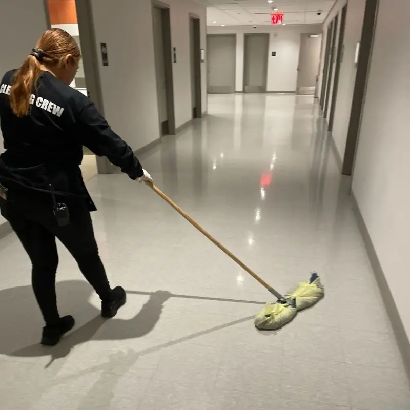 Sweeping vinyl floors in hallways of Bronx Charter School