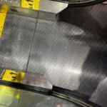 After picture - cleaning metal grid at escalator landing in Tourist Attraction in Manhattan