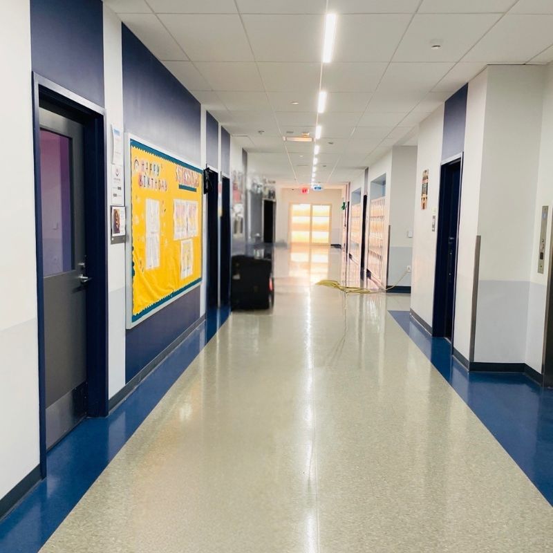 Before Picture - Professional cleaner cleaning vinyl floor in NYC charter school hallway