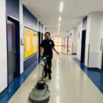 Before Picture - Professional cleaner cleaning vinyl floor in NYC charter school hallway