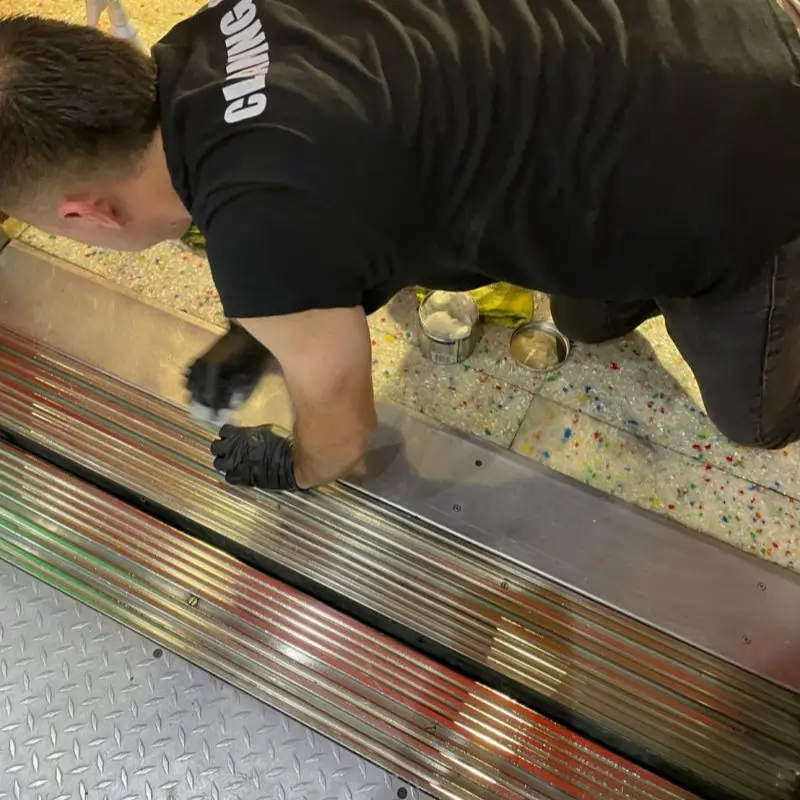 Before picture - detailed cleaning of metal grid and floor of elevator at tourist attraction in Manhattan