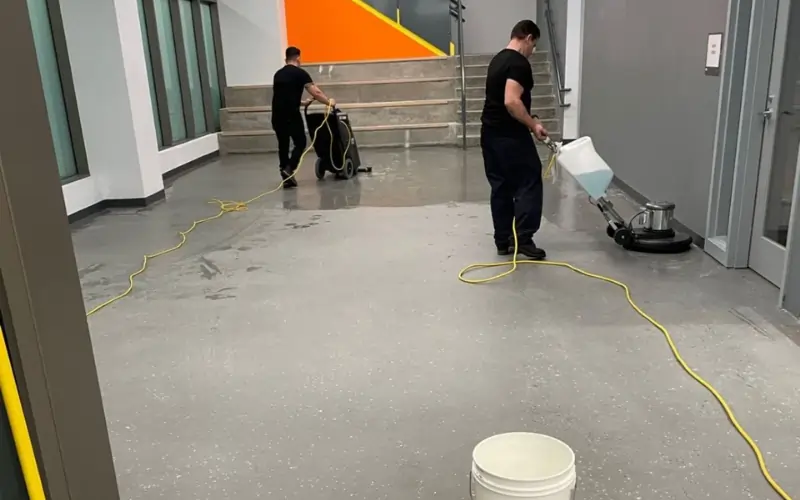 Advantage Cleaning Crew stripping and waxing VCT floors at NYC school